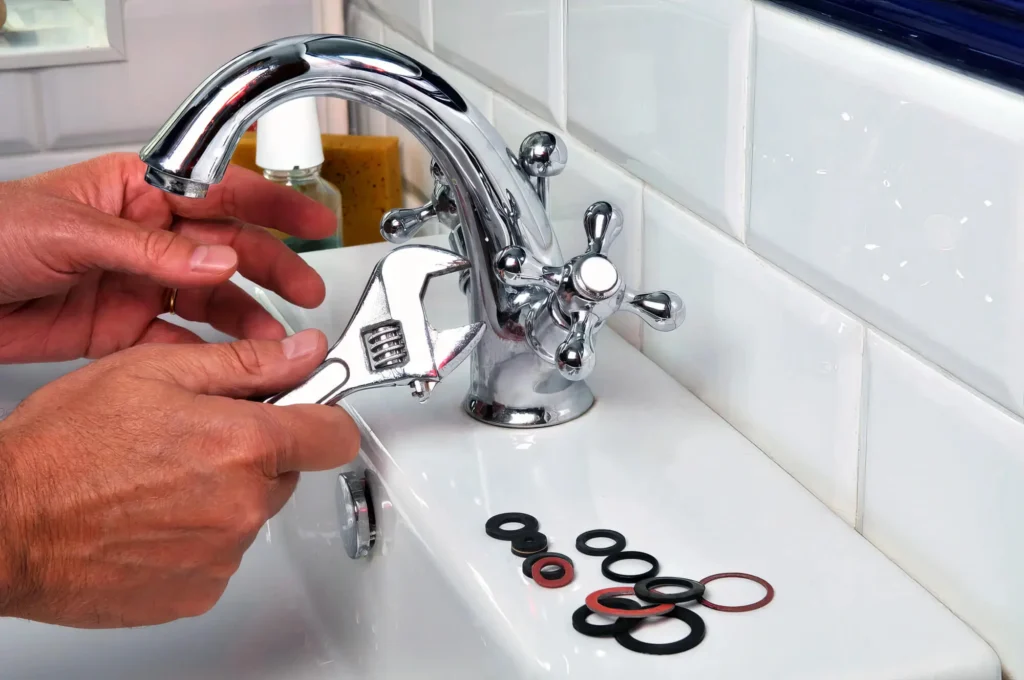 Plumber performing maintenance on a bathroom faucet in San Ramon