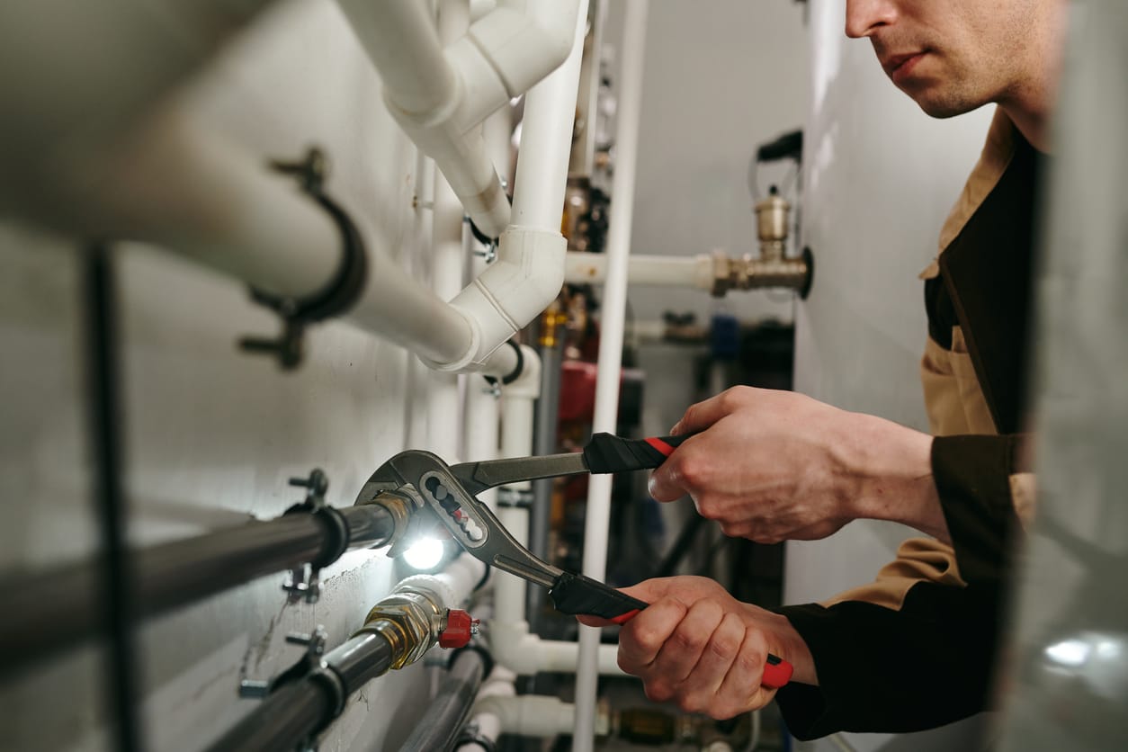 Plumbers maintaining commercial plumbing pipes in San Ramon