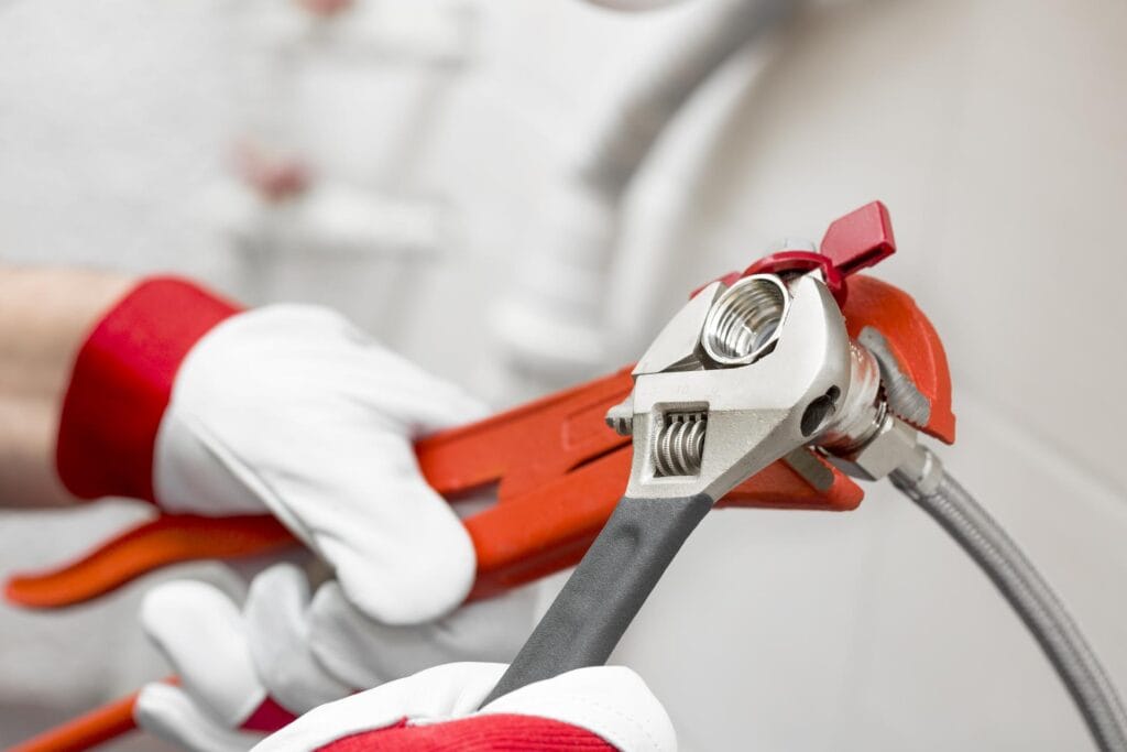 Plumber holding pipe wrenches for an emergency repair in San Ramon