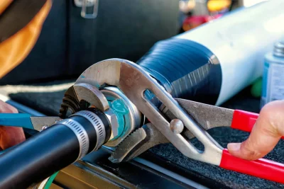 Technician tightening an industrial pipe connection in San Ramon