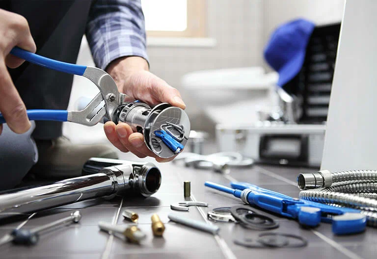 Technician repairing a plumbing fixture with professional tools in San Ramon