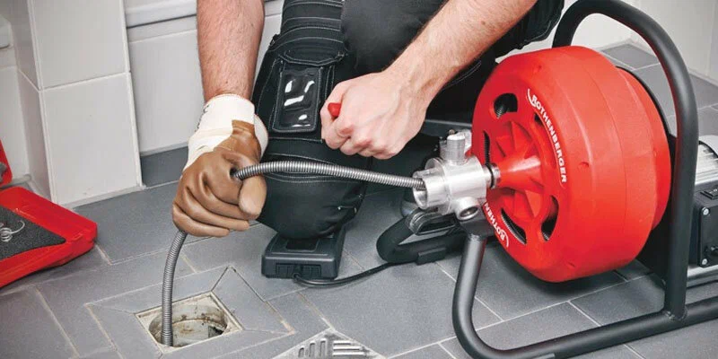 Plumber using a drain-cleaning machine in San Ramon