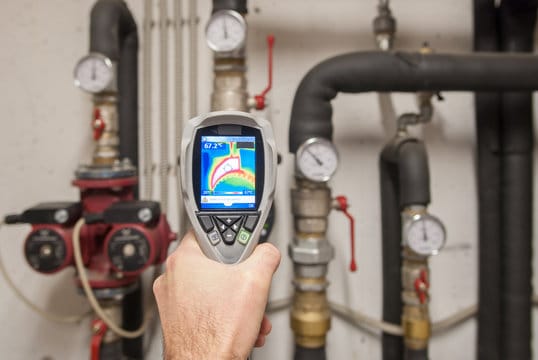 Plumber using a thermal imaging camera to inspect pipes in San Ramon