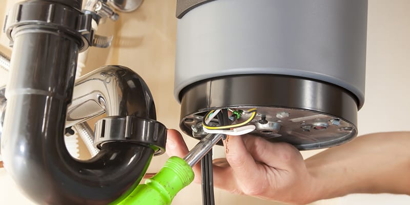 Technician repairing the heating element of a water heater in San Ramon