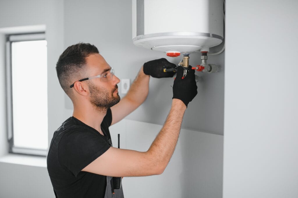Technician performing water heater maintenance in San Ramon