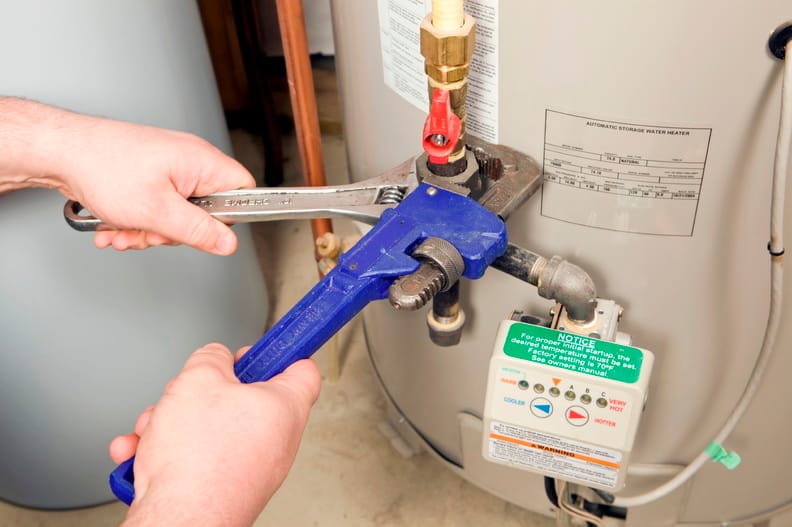 Plumber repairing a water heater valve in San Ramon